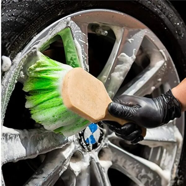 washing car by using green short handle brush